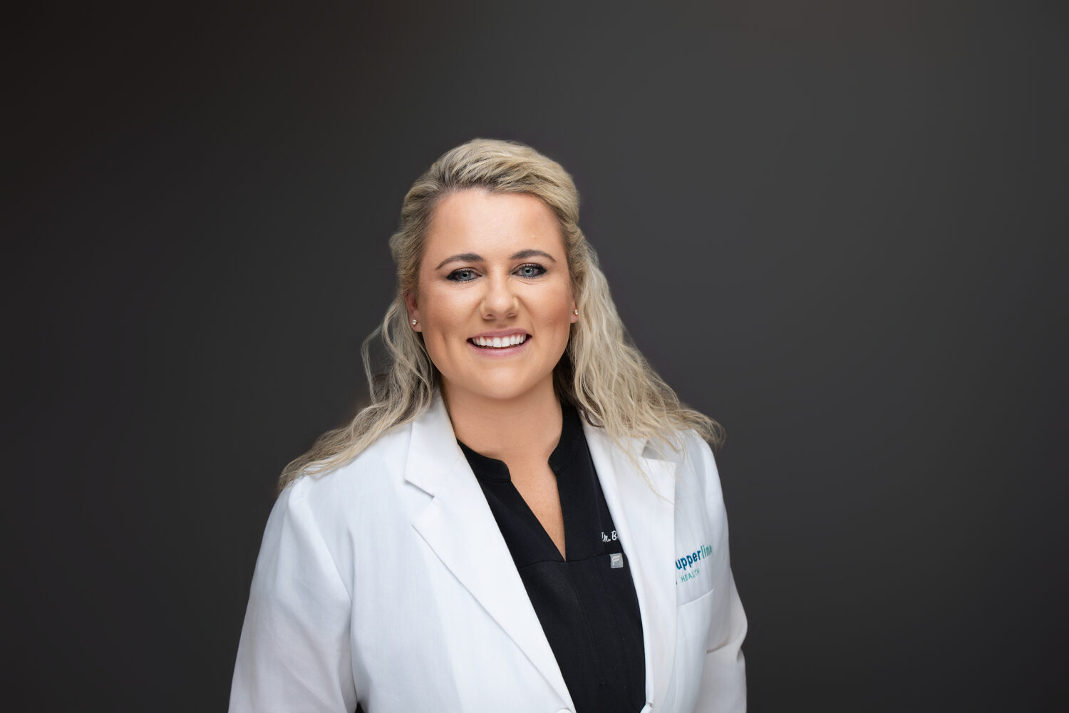 White coat layered over a dark top